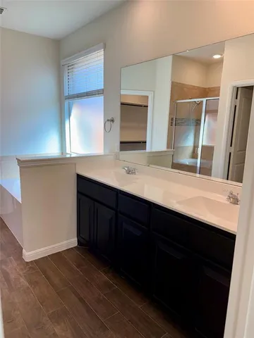 a bathroom with a double vanity sink and a mirror