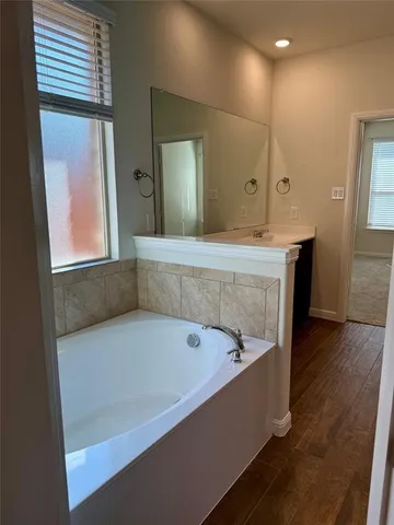 a bathroom with a bathtub and a sink