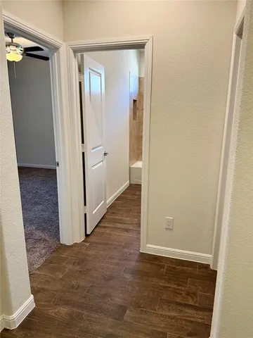 an empty room with wooden floor and closet