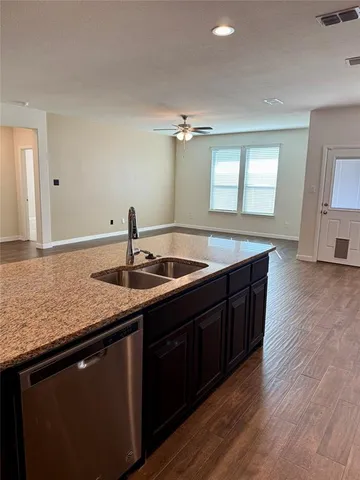 a kitchen with sink and cabinets