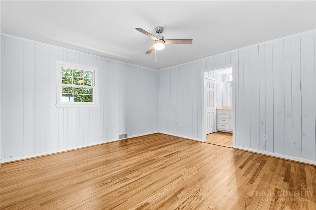 656 Goforth Road Blowing Rock, NC 28605 - Photo 12 of 36 a view of an empty room with wooden floor and a window