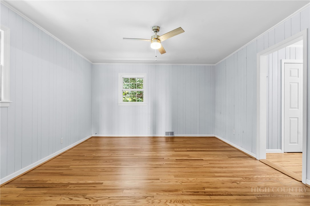 656 Goforth Road Blowing Rock, NC 28605 - Photo 15 of 36 a view of an empty room with wooden floor and a window