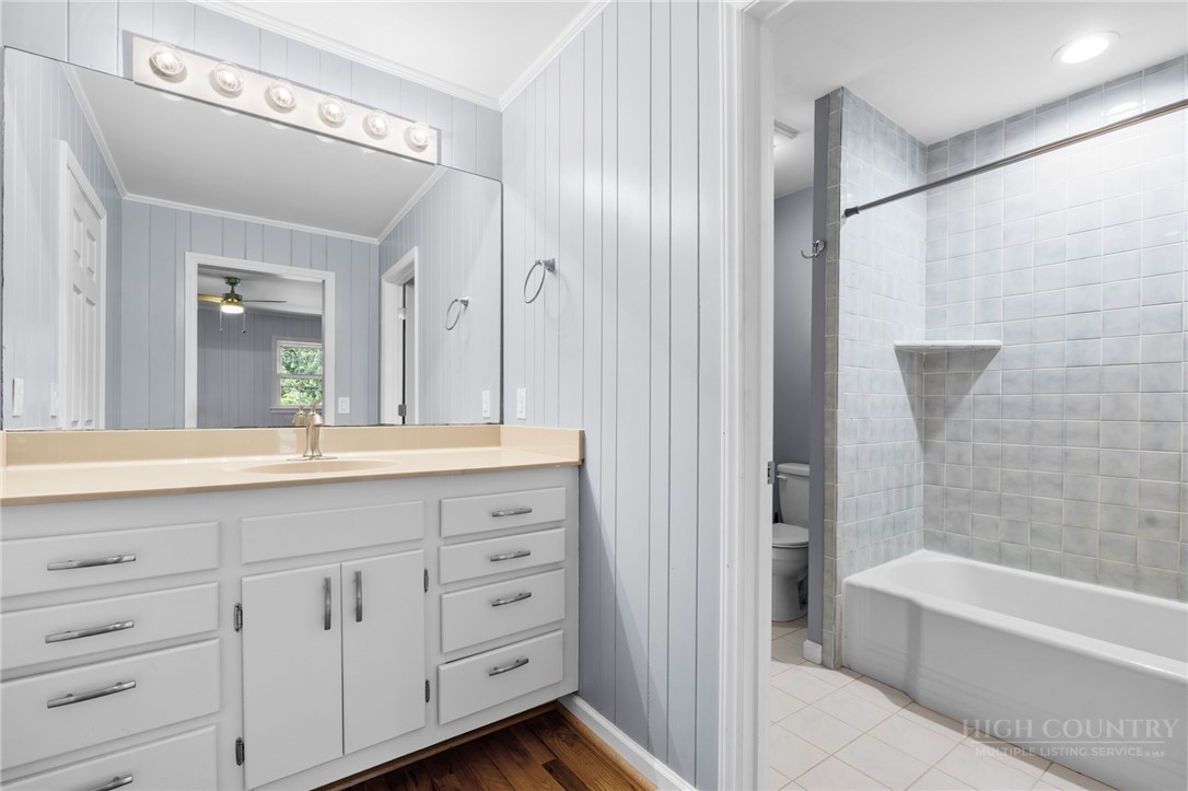 656 Goforth Road Blowing Rock, NC 28605 - Photo 16 of 36 a bathroom with a tub a sink and mirrors