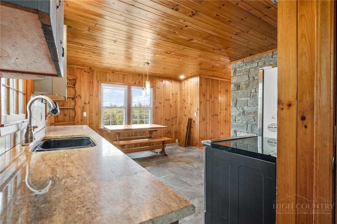 656 Goforth Road Blowing Rock, NC 28605 - Photo 18 of 36 a bedroom with furniture and large windows