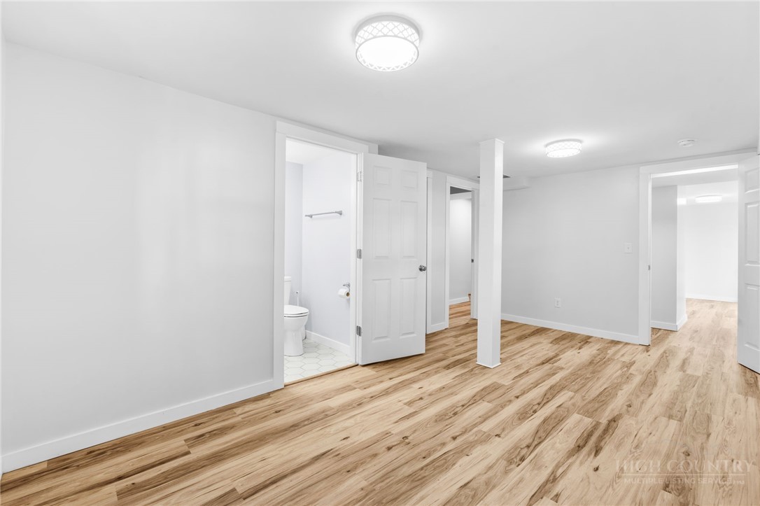656 Goforth Road Blowing Rock, NC 28605 - Photo 22 of 36 a view of an empty room with wooden floor