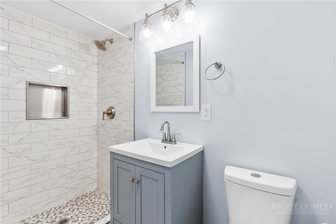 656 Goforth Road Blowing Rock, NC 28605 - Photo 23 of 36 a bathroom with a toilet sink and mirror