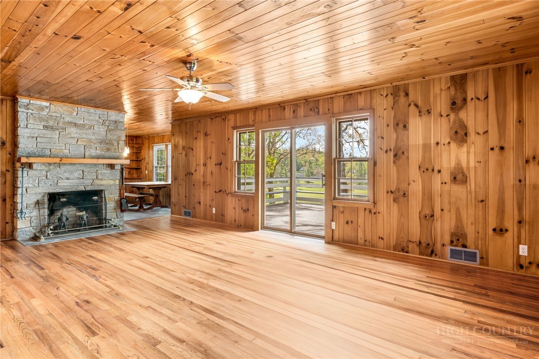 656 Goforth Road Blowing Rock, NC 28605 - Photo 3 of 36 a view of an empty room with wooden floor and a fireplace