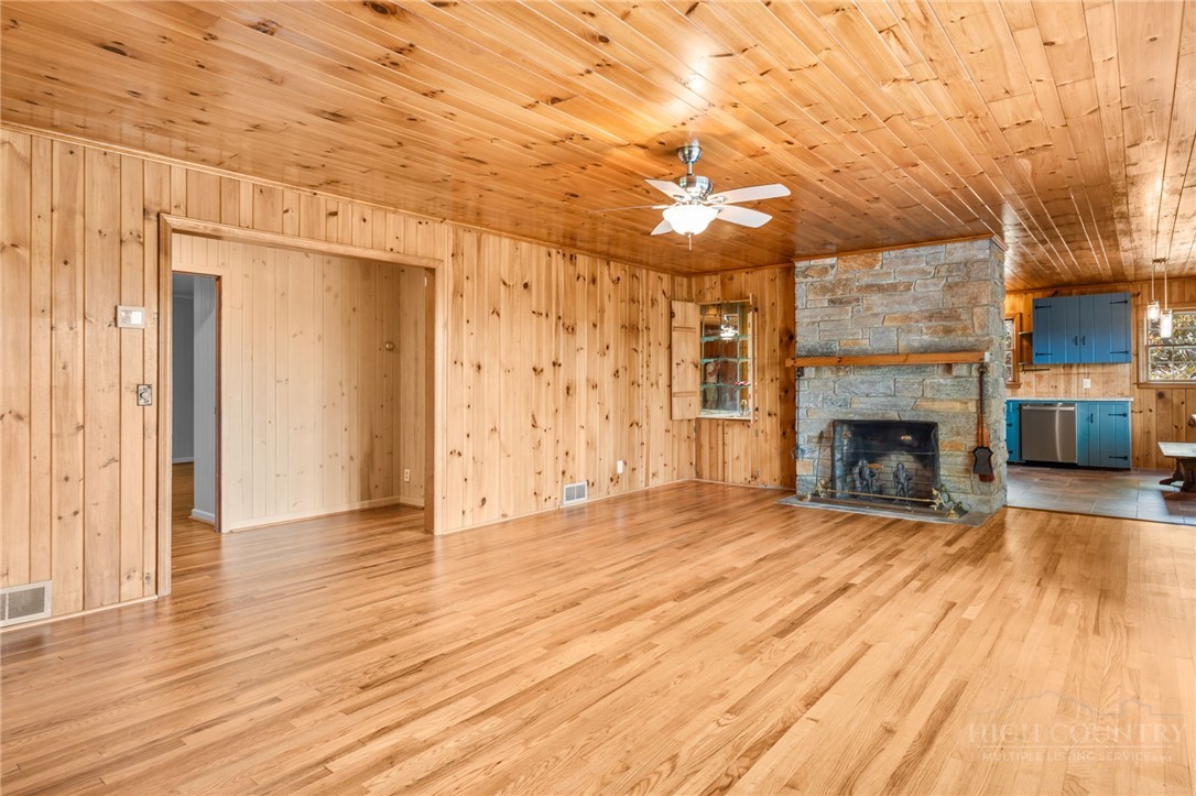 656 Goforth Road Blowing Rock, NC 28605 - Photo 4 of 36 a view of a livingroom with wooden floor and a fireplace