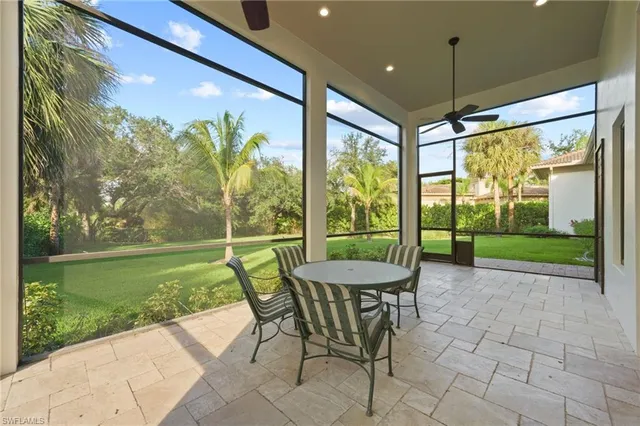a view of a porch with chairs and backyard