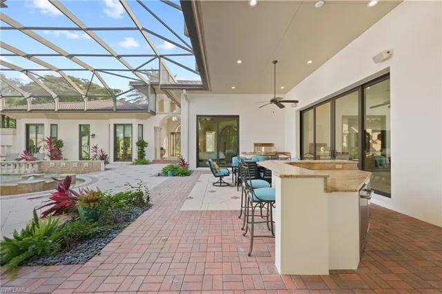 a view of a patio with couches table and chairs and potted plants