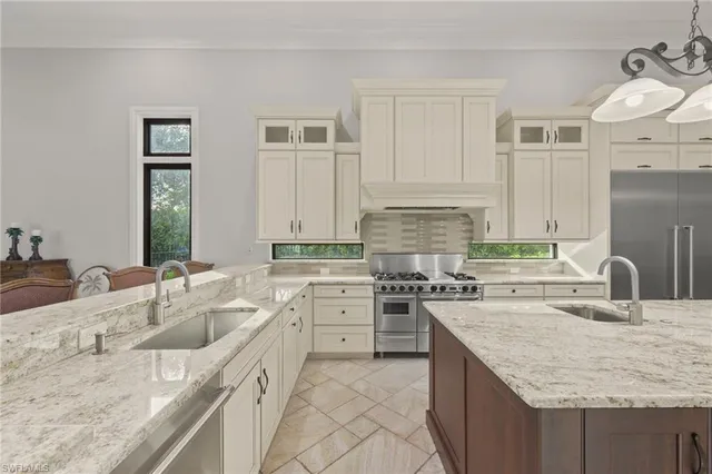 a kitchen with granite countertop a sink stove and cabinets