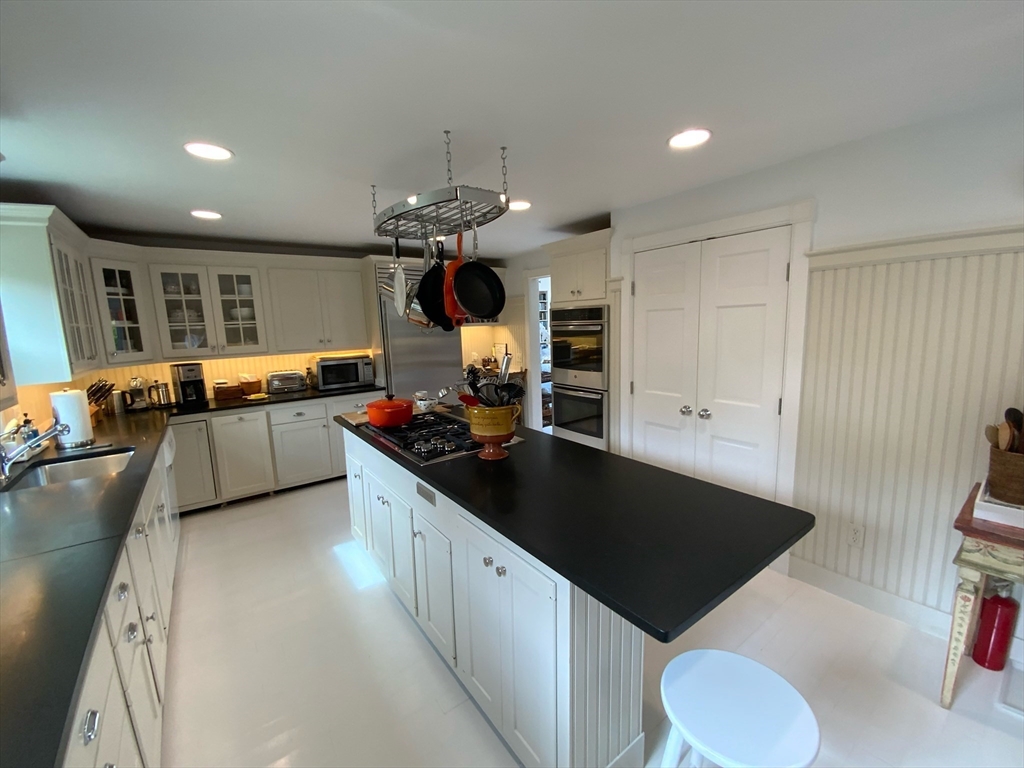 17 Burnell Street Nantucket, MA 02554 - Photo 11 of 24 a kitchen with stainless steel appliances granite countertop a sink stove and refrigerator