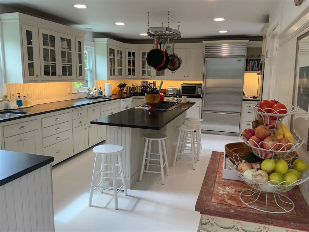 17 Burnell Street Nantucket, MA 02554 - Photo 12 of 24 a kitchen with a sink and cabinets