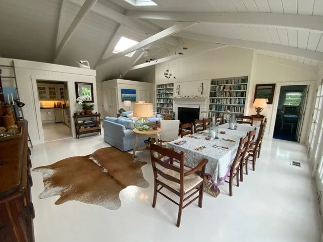 a living room with fireplace furniture and a large window