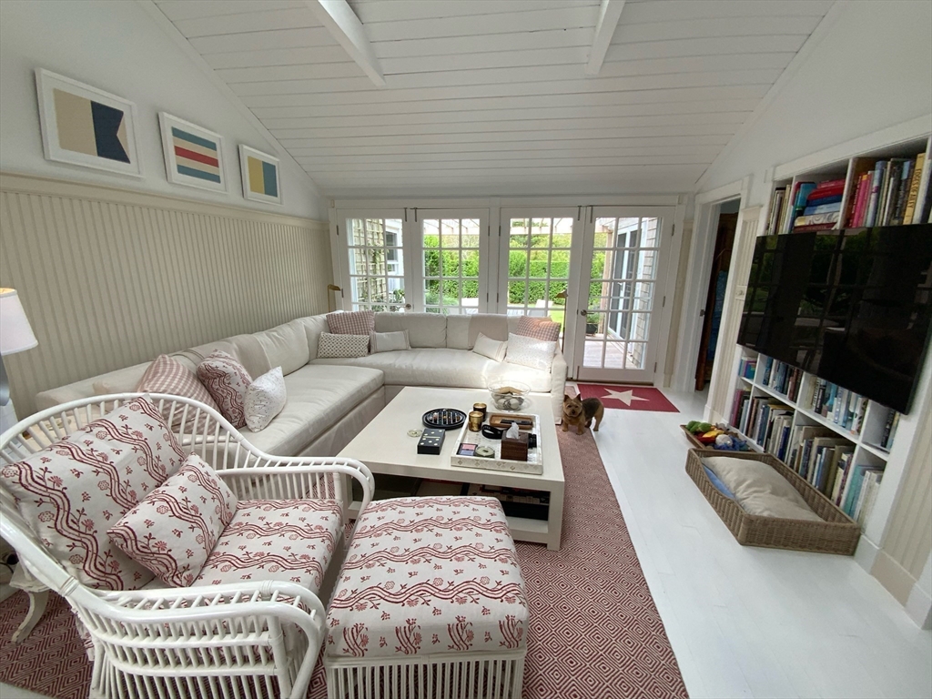17 Burnell Street Nantucket, MA 02554 - Photo 16 of 24 a living room with furniture a flat screen tv and a large window