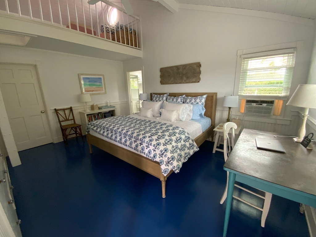 17 Burnell Street Nantucket, MA 02554 - Photo 17 of 24 a bed sitting in a bedroom next to a window with wooden floor