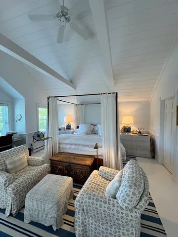 a bedroom with furniture and a window