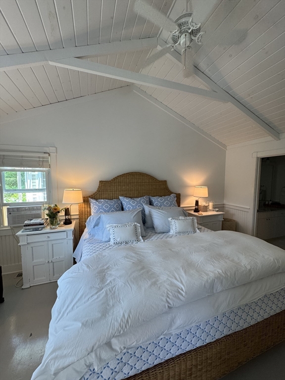 17 Burnell Street Nantucket, MA 02554 - Photo 20 of 24 a bedroom with a large bed and a chandelier