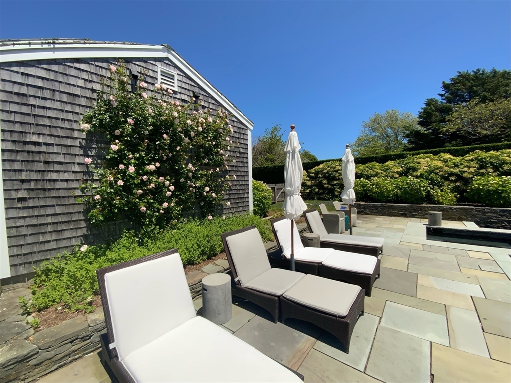 17 Burnell Street Nantucket, MA 02554 - Photo 9 of 24 a view of a patio with couches table and chairs with potted plants and big yard