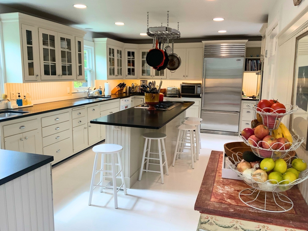 17 Burnell Street Nantucket, MA 02554 - Photo 10 of 24 a kitchen with a sink and cabinets