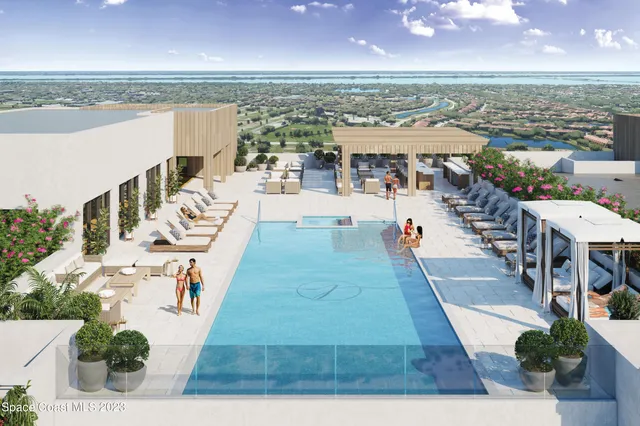 a view of swimming pool with outdoor seating and ocean view