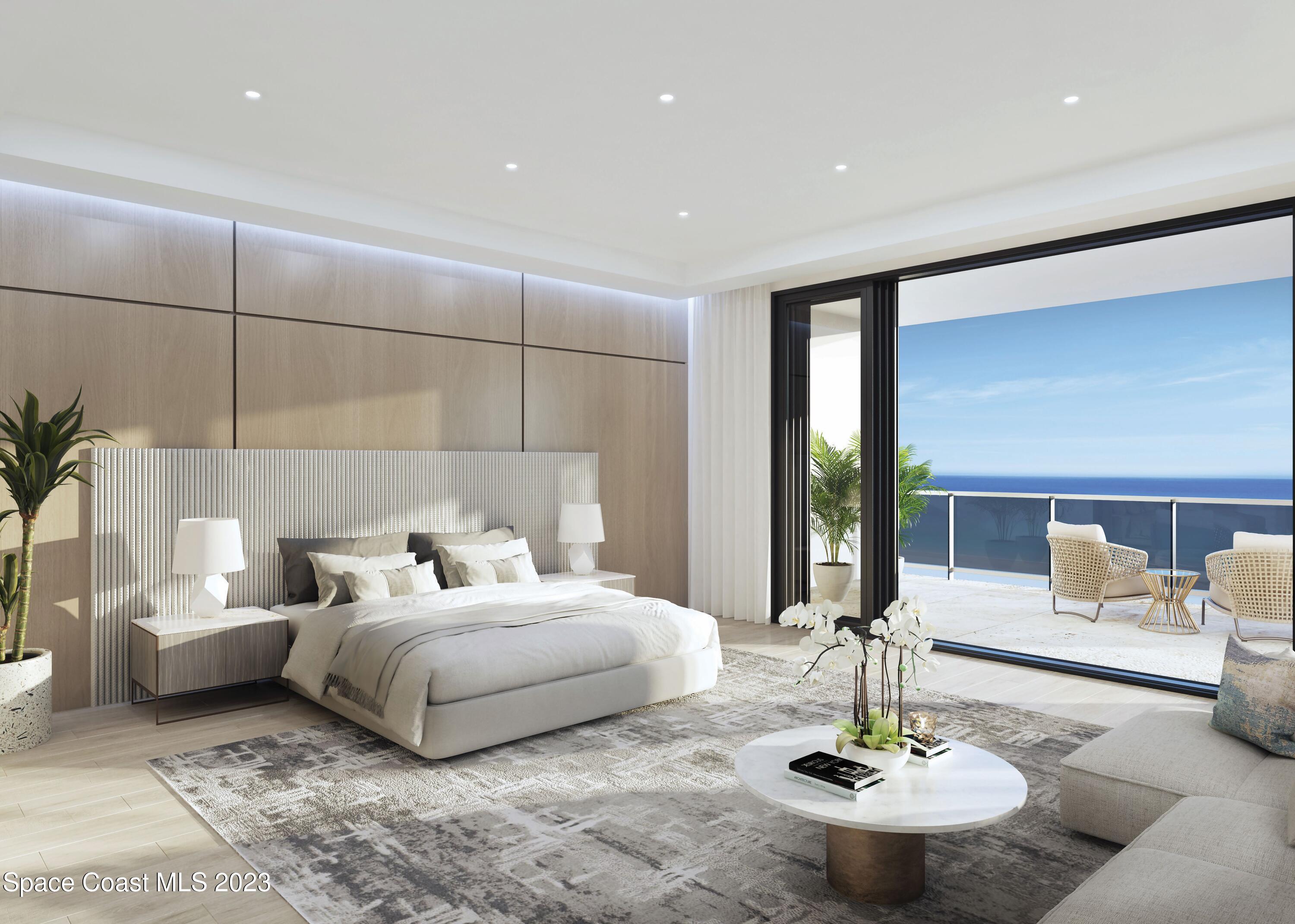 604 Highway A1a Satellite Beach, Unit 902 Satellite Beach, FL 32937 - Photo 7 of 18 a bedroom with a bed and chandelier