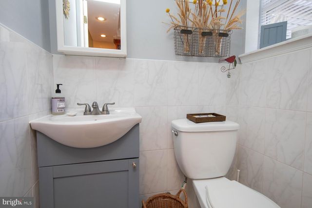 a bathroom with a sink a toilet and mirror
