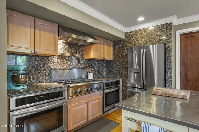 a kitchen with stainless steel appliances granite countertop a sink stove and refrigerator