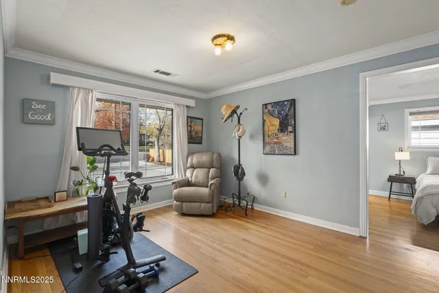 a view of a livingroom with workspace and a window