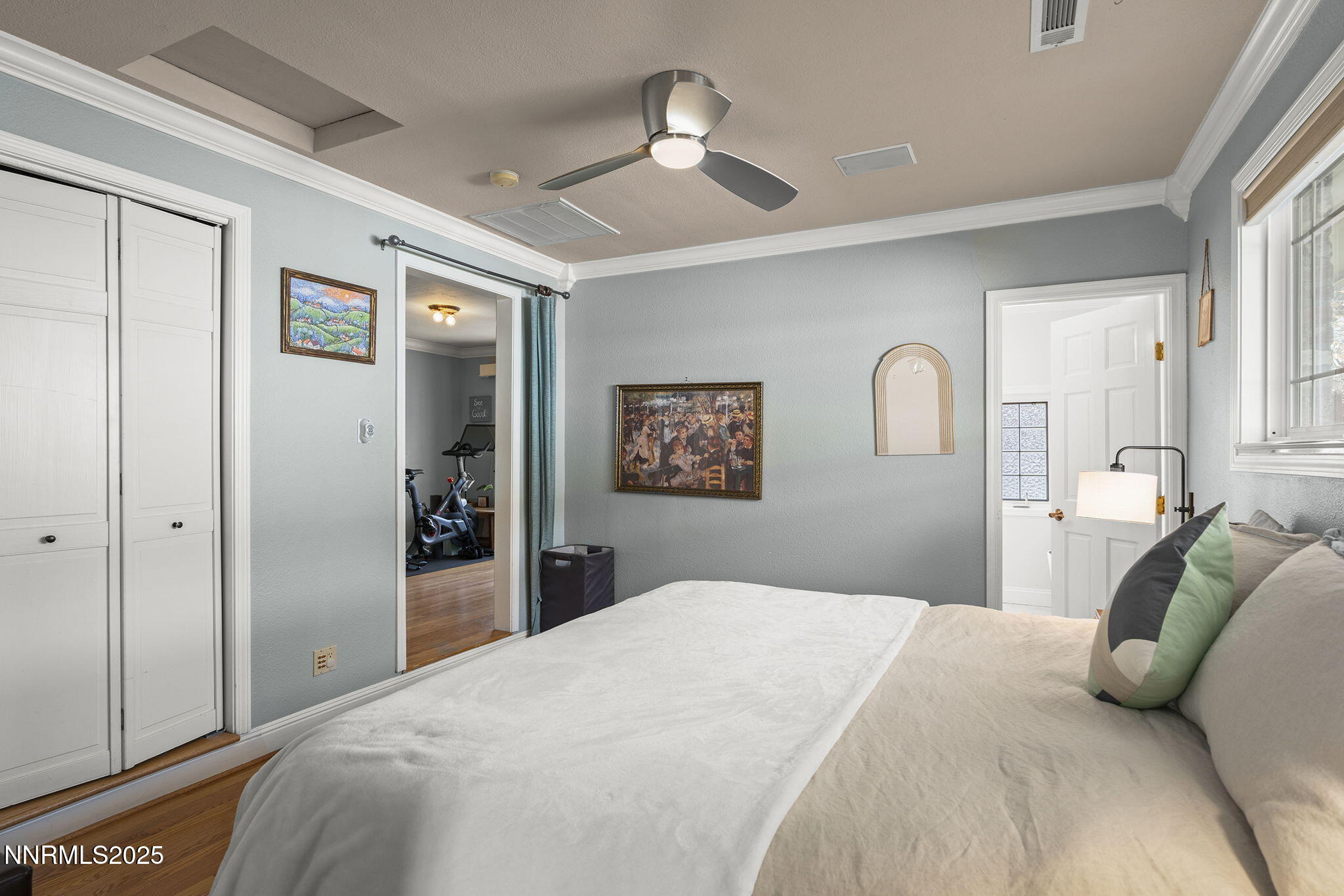 2260 Sunrise Drive Reno, NV 89509 - Photo 19 of 44 a bedroom with a large bed and a chandelier