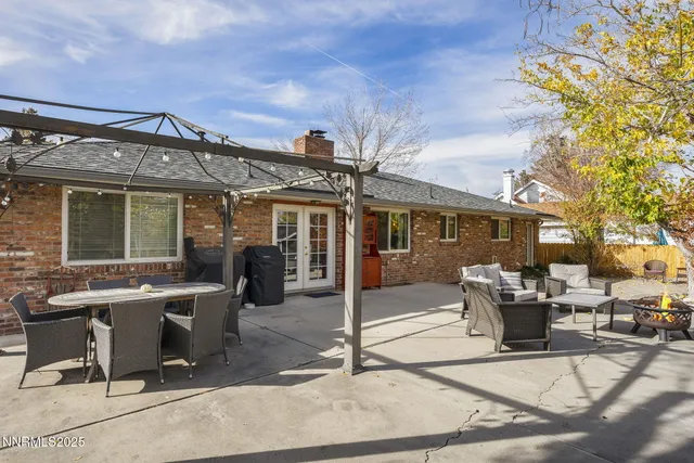 a view of a patio with table and chairs