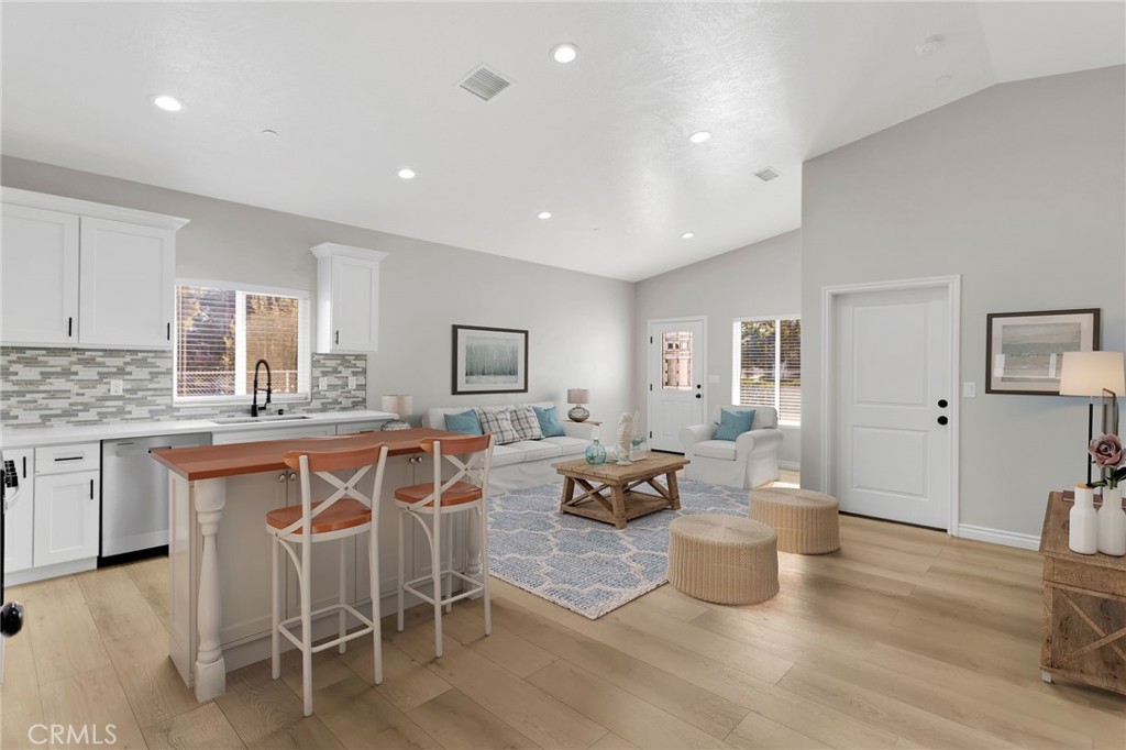 16150 Smoke Tree Street Hesperia, CA 92345 - Photo 11 of 32 a living room with furniture a wooden floor and a sink