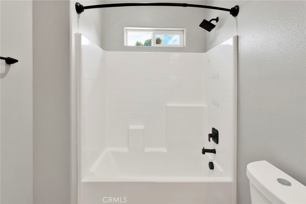 16150 Smoke Tree Street Hesperia, CA 92345 - Photo 19 of 32 a bathroom with a bathtub and shower