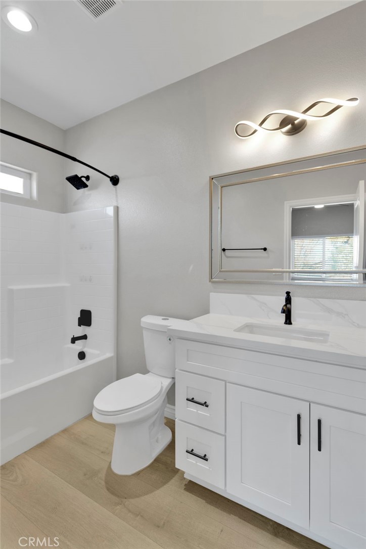 16150 Smoke Tree Street Hesperia, CA 92345 - Photo 20 of 32 a bathroom with a toilet a sink and a bathtub