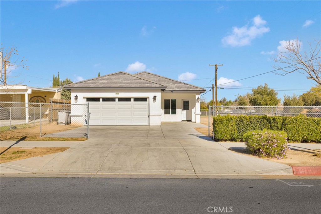 16150 Smoke Tree Street Hesperia, CA 92345 - Photo 2 of 32 a front view of a house with a yard