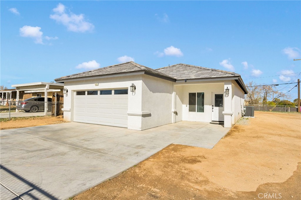 16150 Smoke Tree Street Hesperia, CA 92345 - Photo 5 of 32 a view of a white house with a outdoor space and sitting space