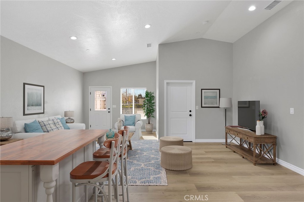 16150 Smoke Tree Street Hesperia, CA 92345 - Photo 9 of 32 a living room with furniture a flat screen tv and a table