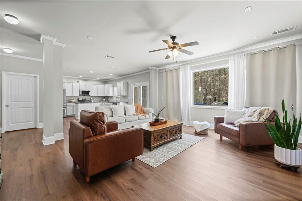 780 Springs Crest Drive Dallas, GA 30157 - Photo 11 of 47 a living room with furniture or wooden floor and a chandelier