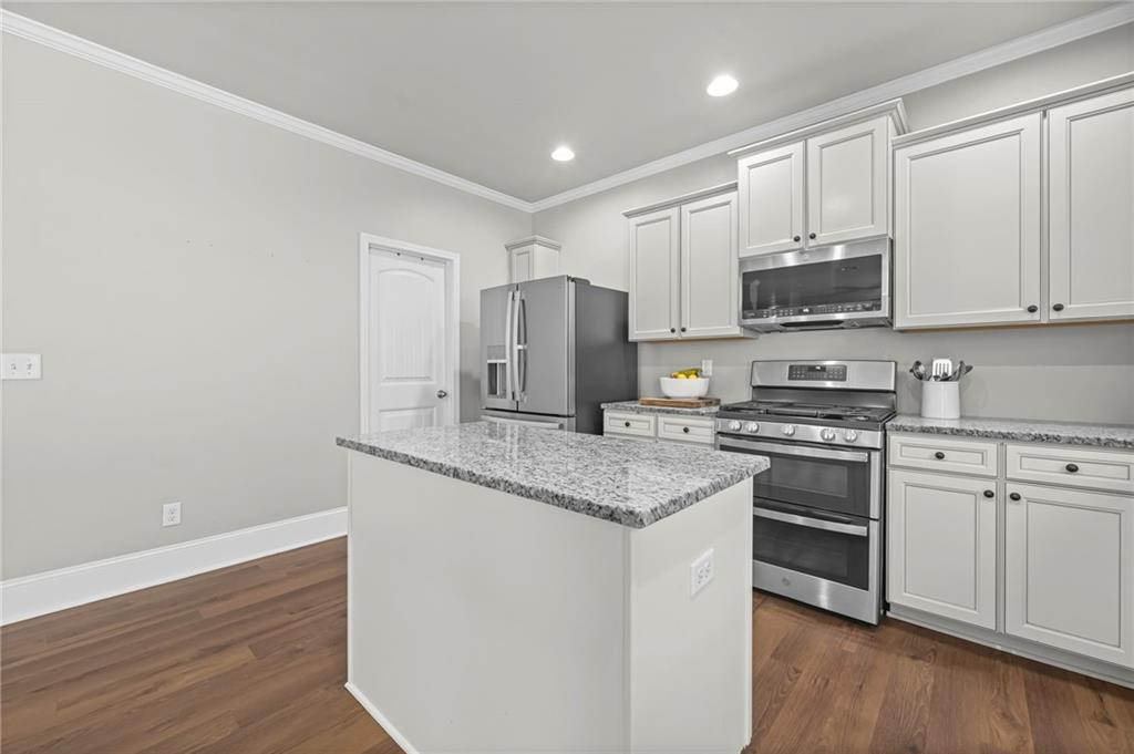 780 Springs Crest Drive Dallas, GA 30157 - Photo 14 of 47 a kitchen with stainless steel appliances granite countertop a stove a sink and a refrigerator
