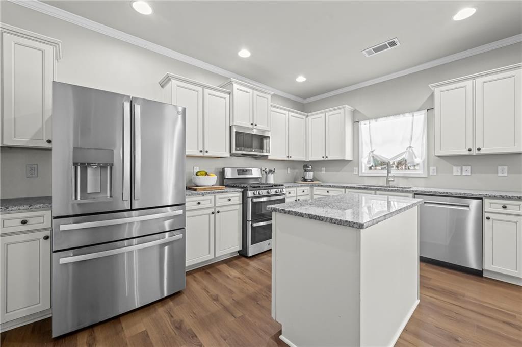 780 Springs Crest Drive Dallas, GA 30157 - Photo 15 of 47 a kitchen with granite countertop white cabinets and stainless steel appliances