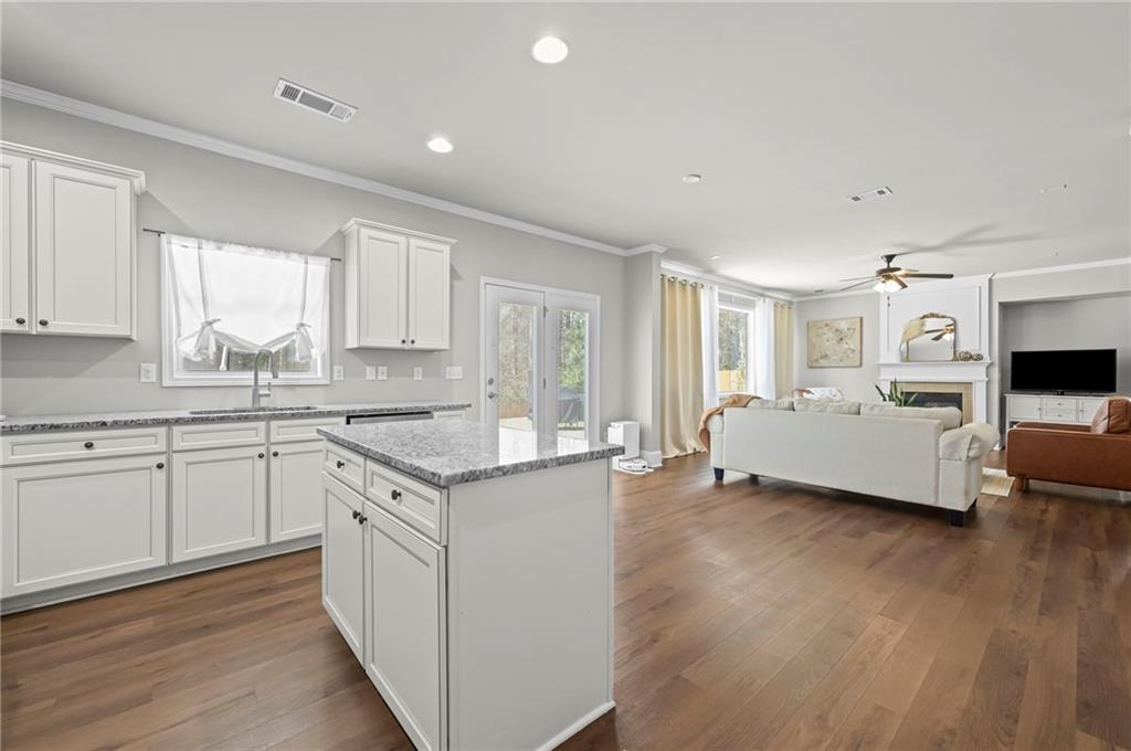 780 Springs Crest Drive Dallas, GA 30157 - Photo 16 of 47 a kitchen with granite countertop a sink and cabinets with wooden floor