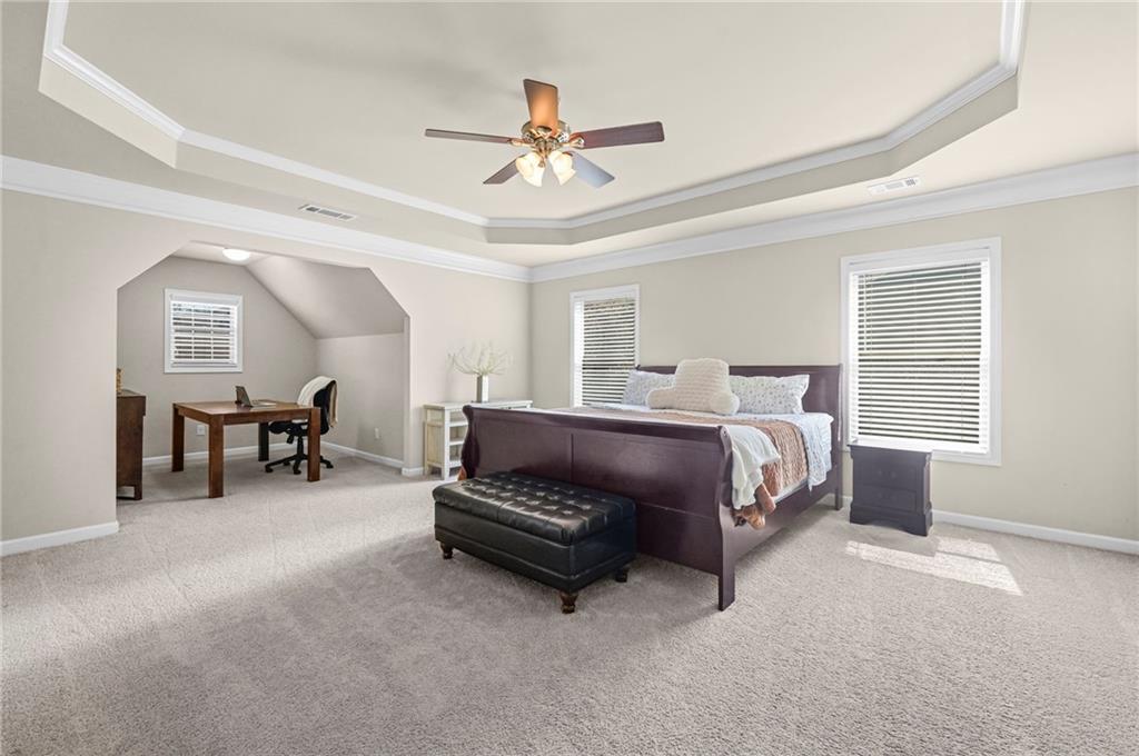 780 Springs Crest Drive Dallas, GA 30157 - Photo 17 of 47 a spacious bedroom with a bed and a chandelier