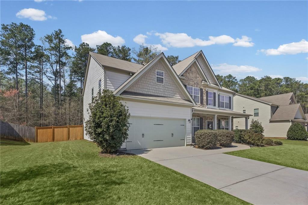 780 Springs Crest Drive Dallas, GA 30157 - Photo 2 of 47 a front view of a house with a garden
