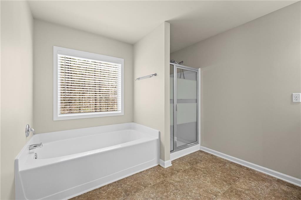 780 Springs Crest Drive Dallas, GA 30157 - Photo 24 of 47 a bathroom with bathtub and a shower