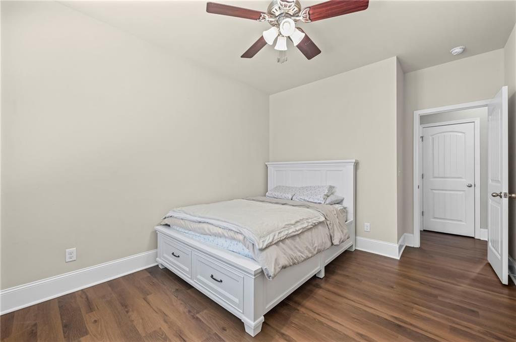 780 Springs Crest Drive Dallas, GA 30157 - Photo 30 of 47 a bedroom with a bed and wooden floor
