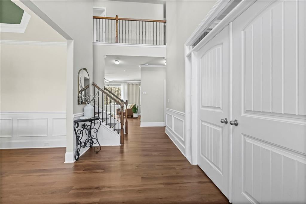 780 Springs Crest Drive Dallas, GA 30157 - Photo 3 of 47 a view of a hallway with wooden floor and staircase