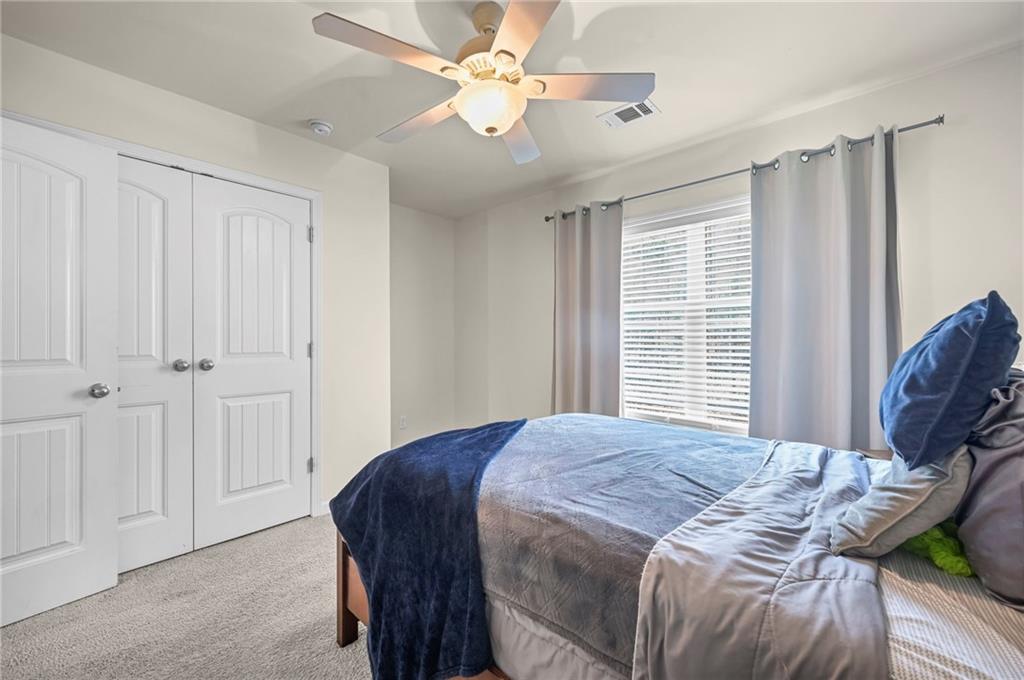 780 Springs Crest Drive Dallas, GA 30157 - Photo 35 of 47 a bedroom with a bed and a chandelier