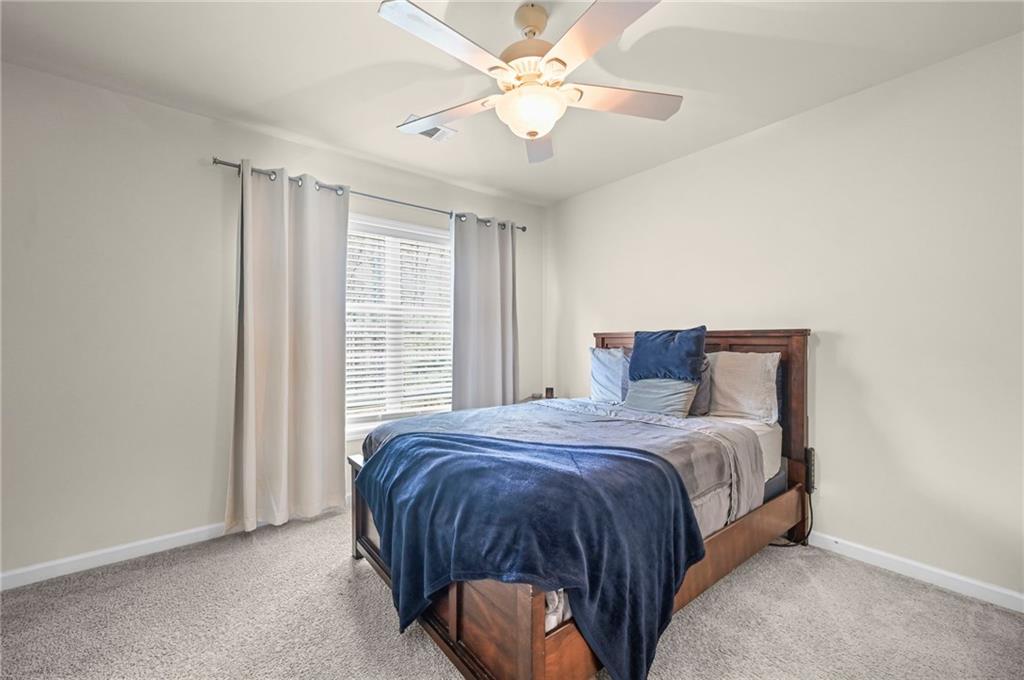 780 Springs Crest Drive Dallas, GA 30157 - Photo 36 of 47 a bedroom with a bed and a chandelier