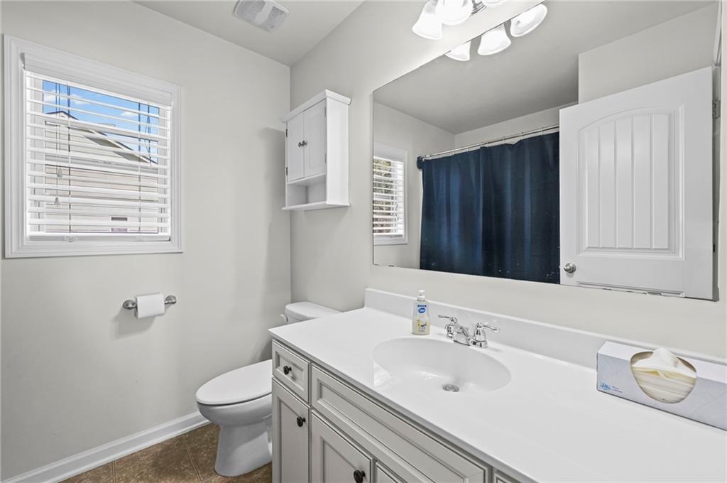 780 Springs Crest Drive Dallas, GA 30157 - Photo 37 of 47 a bathroom with a granite countertop sink toilet and a mirror