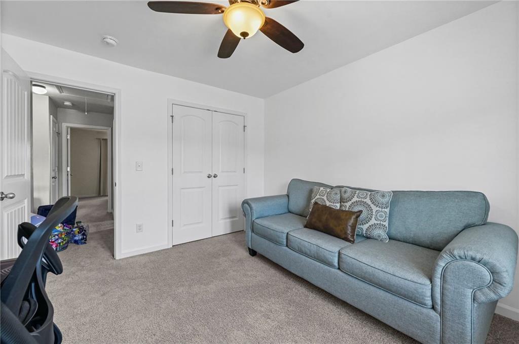 780 Springs Crest Drive Dallas, GA 30157 - Photo 39 of 47 a living room with furniture and a ceiling fan